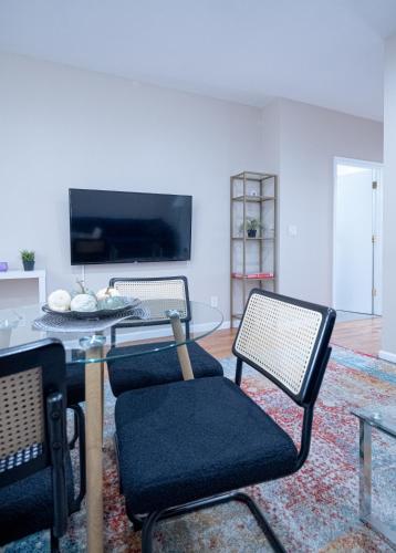 a living room with two chairs and a glass table at 3BR apt two blocks to Central Park elevator, laundry, virtual doorman in New York