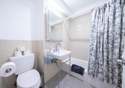 a bathroom with a toilet and a sink at 3BR apt two blocks to Central Park elevator, laundry, virtual doorman in New York