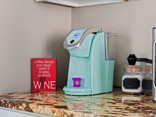 a blue mixer sitting on a counter next to a sign at Cozy Home Apartments in Louisville