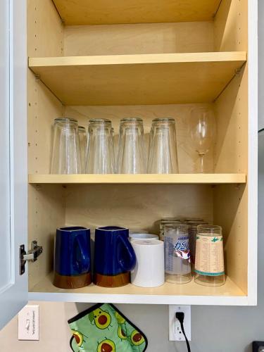 a shelf with glass jars and other items on it at Cozy Home Apartments in Louisville