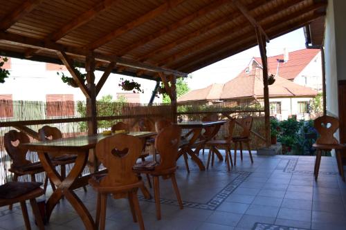 a group of wooden tables and chairs on a patio at Casa Pleșca in Sibiu