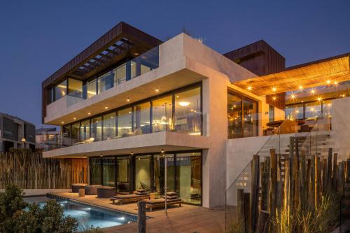 a large house with a pool in front of it at Areias do Seixo in Santa Cruz