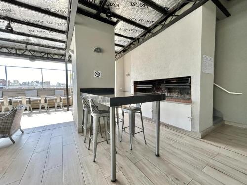 a kitchen with a table and chairs and a fireplace at Modern and Warm Apartment in Buenos Aires
