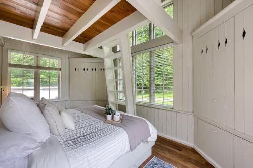 a bedroom with a bed in a room with windows at Pool Cottage at Roundtop Estate couples oasis in Wrightsville