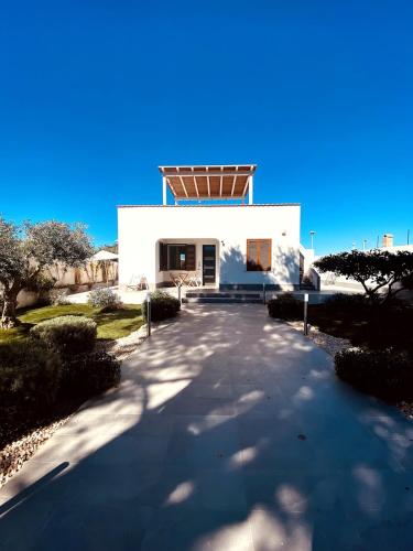 a white building with a roof on top of it at Casa de Campo in Valderice