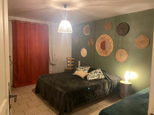 a bedroom with a bed and a red wall at A La Mare du Vieux Chêne in Bellegarde-Poussieu