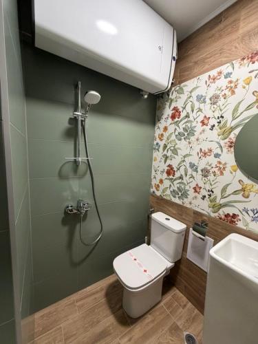 a small bathroom with a toilet and a shower at Yantra Tower Deluxe in Gabrovo