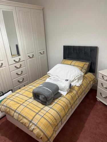 a bedroom with a bed with towels on it at King Edward house in Rhymney