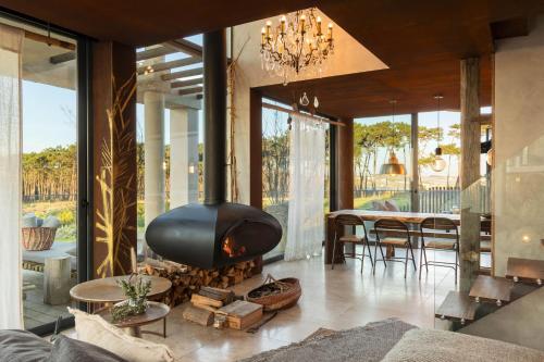 a living room with a fireplace and a dining room at Areias do Seixo in Santa Cruz