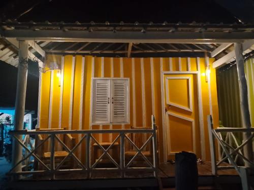 a house under construction with a yellow and white wall at The Two Tigers - Sok San Village in Phumĭ Kaôh Rŏng