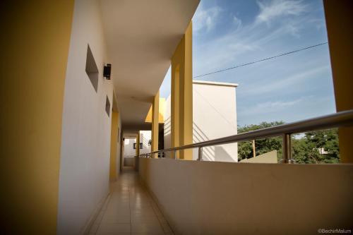 a hallway of a building with a balcony at Suite Monoapparte in Nouakchott