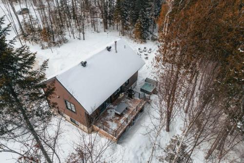 an aerial view of a house in the snow at Nature & lake access Tremblant in Saint-Rémi-dʼAmherst