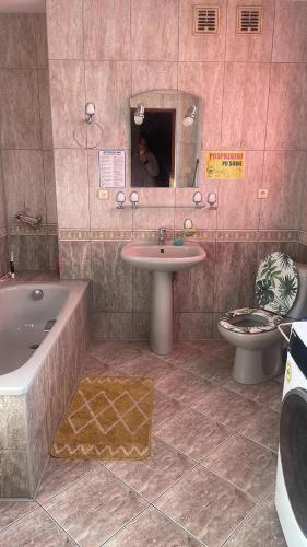 a bathroom with a tub and a sink and a toilet at Second&Home in Przeźmierowo
