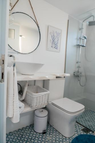 a bathroom with a white toilet and a mirror at Agapi in Xylokastro