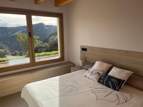 Ένα ή περισσότερα κρεβάτια σε δωμάτιο στο Cal Rocamarti