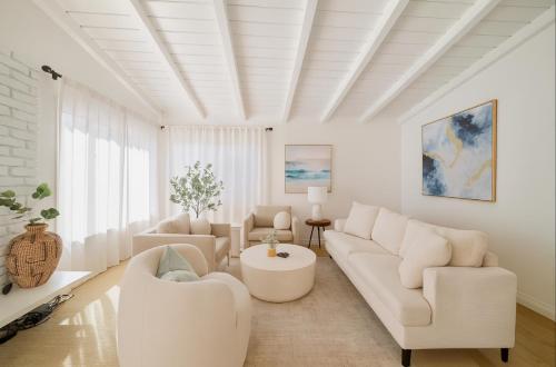 a living room with white furniture and a white ceiling at Steps to Sand Cozy 3BR Partial Ocean Views in Manhattan Beach