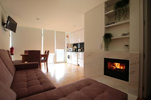 a living room with a couch and a fireplace at OPORTO GUEST Natária Flats with Parking in Porto