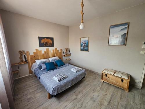 a bedroom with a bed and a table in it at Magnifique villa moderne Jacuzzi 4 chambres 3 salle de bain proche plage centre ville activité in Le Barcarès