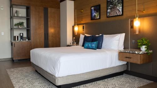 a bedroom with a large bed with a large white bedspread at Snoqualmie Casino & Hotel in Snoqualmie