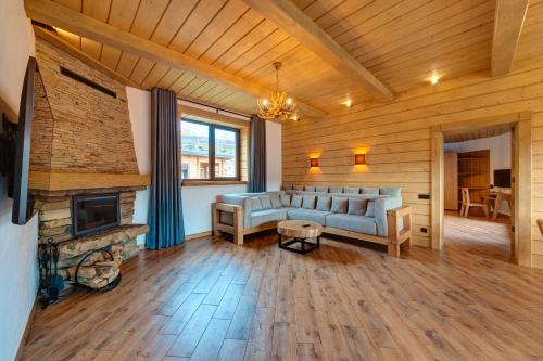 a living room with a couch and a fireplace at Шале 5 Стефанія in Mykulychyn
