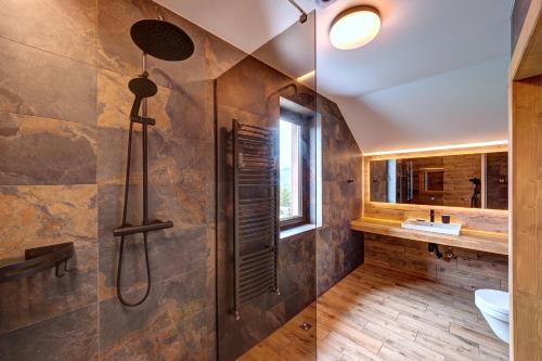 a bathroom with a shower and a sink at Шале 5 Стефанія in Mykulychyn