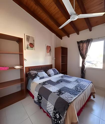 a bedroom with a bed and a ceiling fan at Copos de Nieve in El Bolsón
