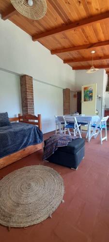 a room with a table and a bed and a rug at Departamento Interno 1 in Santo Tomé