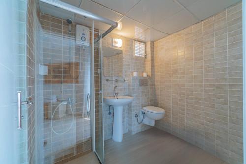 a bathroom with a toilet and a sink and a shower at Club Sun Paradise Hotel in Alanya