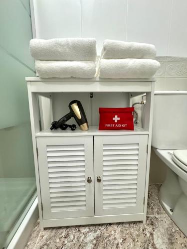 a white shelf in a bathroom with towels at La Macarena Torrevieja in Torrevieja