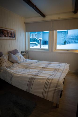 a large bed in a room with a window at Charming apartment with two bedroms and beautifull sea view in Fauske in Fauske
