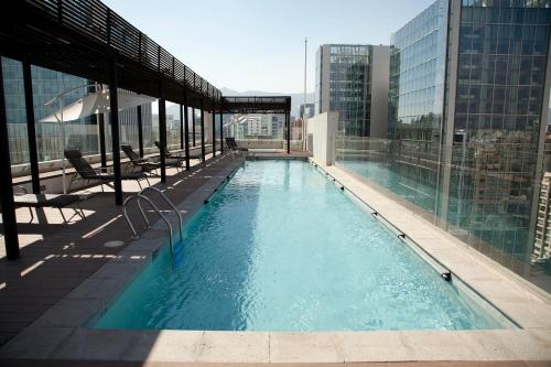 a swimming pool on the top of a building at Sunset Aparts in Santiago