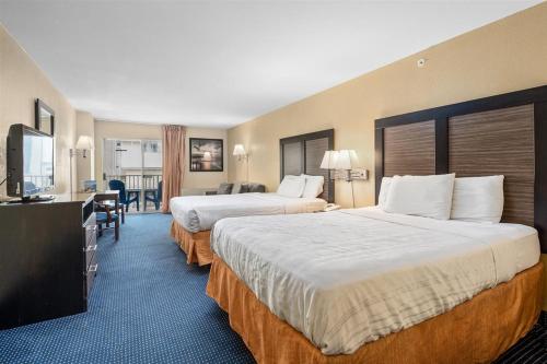a hotel room with two beds and a television at Crystal Beach Hotel in Ocean City