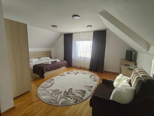 a living room with a couch and a bed at Casa Baraceanu Bran in Bran
