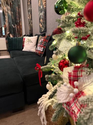 a living room with a christmas tree and a couch at VOK Luxury Home I Tropical Living in Arad