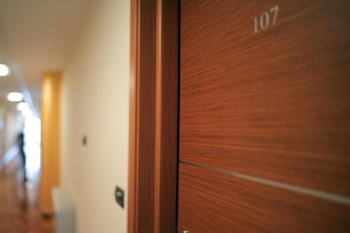 a close up of a wooden door in a room at Draconerium Hotel in Dronero
