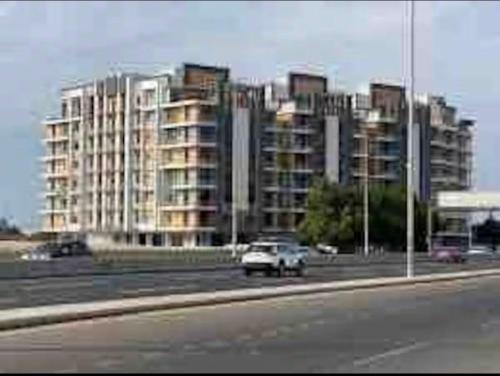 a car driving on a highway with buildings in the background at Golden Studios in Jeddah