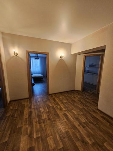 an empty room with wood floors and two doors at Яровиця 61 in Lutsk