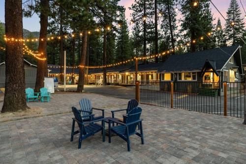 two chairs and a table in front of a house with lights at Adventure Lodge in South Lake Tahoe