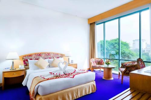 a hotel room with a bed and a large window at HOTEL LAKE CASTLE - Parkview in Dhaka