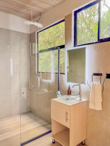 a bathroom with a sink and a glass shower at Cabaña Elvira in La Cruz
