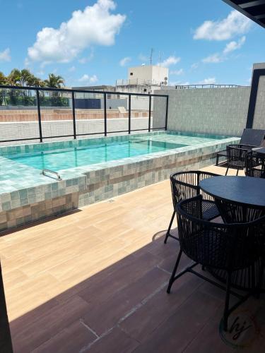 a swimming pool on the roof of a building at Mares 502 in Tambaú