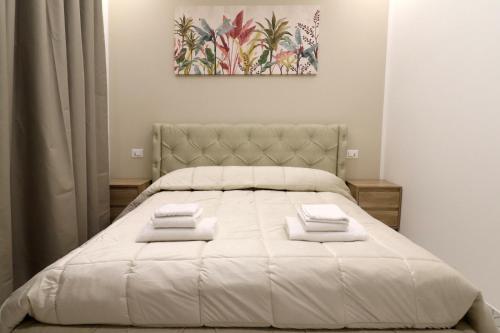 a bedroom with a large bed with white sheets at b&b la cattedrale in Avezzano