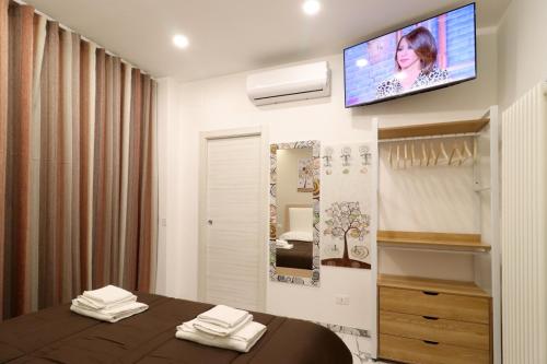 a bedroom with a bed and a tv on the wall at b&b la cattedrale in Avezzano