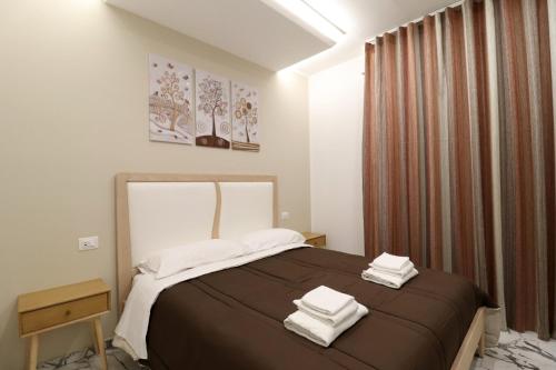 a bedroom with a bed with two towels on it at b&b la cattedrale in Avezzano