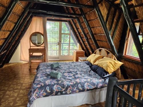 a bedroom with a bed in a attic at Amanda's Retreat in Buffelspoort