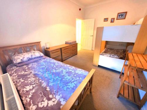 ein Schlafzimmer mit einem Bett und einem Schreibtisch und einem Bett sidx sidx sidx in der Unterkunft 1 Belmont Court in Woolacombe