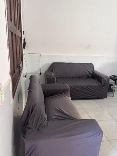 a living room with two couches and a couch at Casa praia do frances in Marechal Deodoro