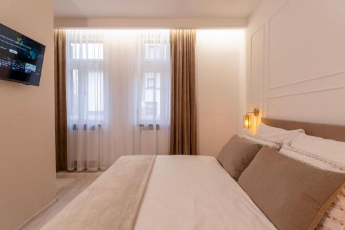 a bedroom with a bed and a window at Kazimierz Residence Apartments Parking - by Staymoovers in Krakow