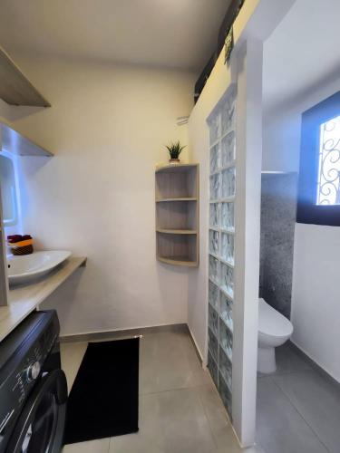 a bathroom with a toilet and a sink at Contemporary apartment, sea view in Lomé