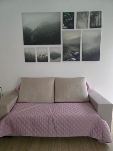 a bed in a room with pictures on the wall at My Dream in Penha Garcia